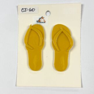 Pair of yellow flip-flops mounted on a white display card, front view showing thong straps