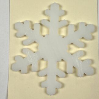 White snowflake cutout on a cream greeting card background