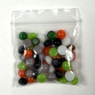 Clear resealable bag filled with assorted small colorful jelly beans (green, orange, white, black, red, purple, and gray).