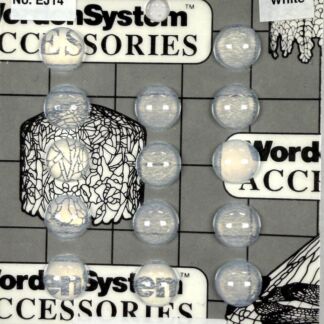 Close-up of a game board with cracked-pattern blocks and scattered blue marbles, featuring the logos 'Word System Accessories' and 'JEWELS MADE IN GERMANY'