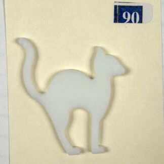 White cat-shaped paper cutout mounted on a pale yellow background with a blue 90 label in the top-right corner